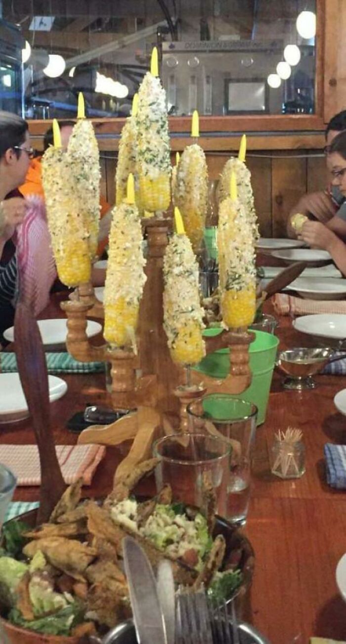 Whole Corn With Garnish Served On Candlestick
