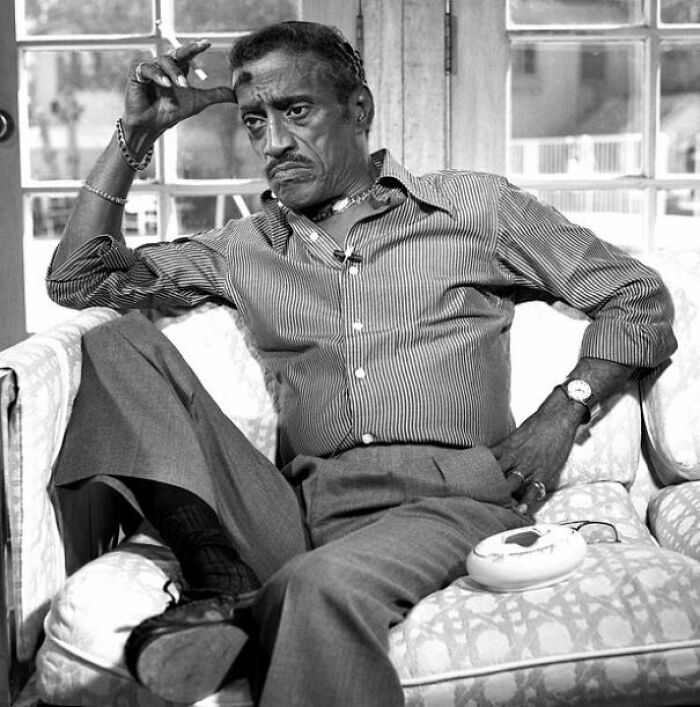 Black and white picture of Sammy Davis Jr sitting and looking