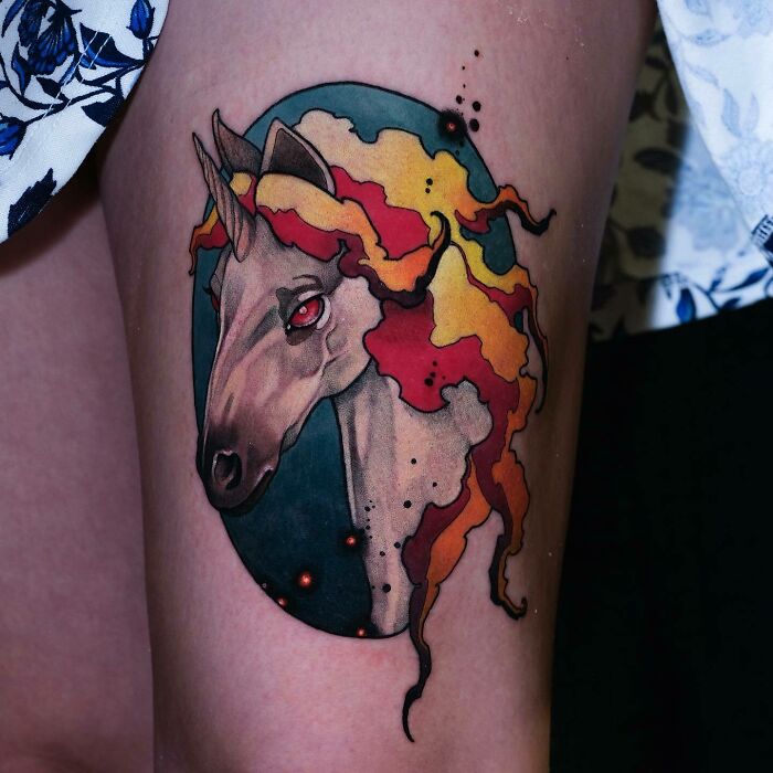 Unicorn with fire hairs leg tattoo