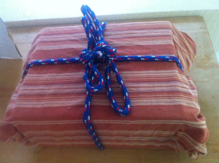 This Is How My Husbands Wraps Gifts. That Is An Old Tablecloth And Rope.. He Said "What? I'm Going Green"