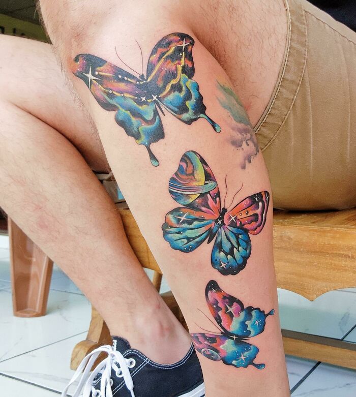 Psychedelic colorful butterflies with stars leg tattoo