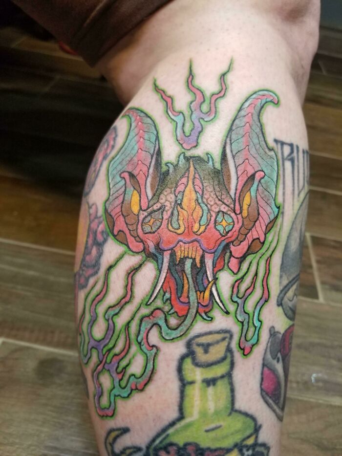 Colorful bat leg tattoo