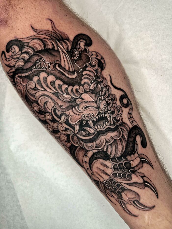 Angry dragon leg tattoo