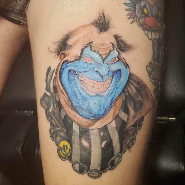 Trippy evil clow with blue face leg tattoo