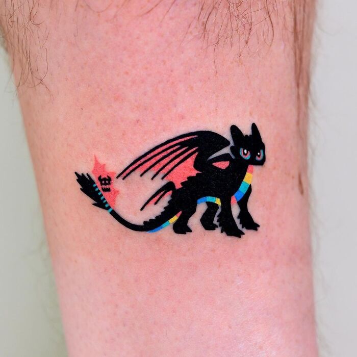 Colorful Toothless from "How To Train Your Dragon" leg tattoo