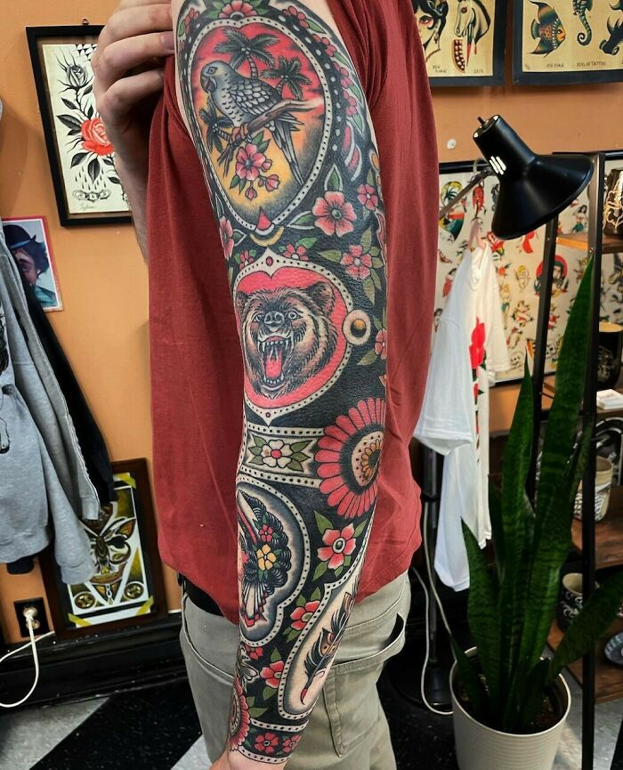 Colorful animal with flowers arm sleeve tattoo