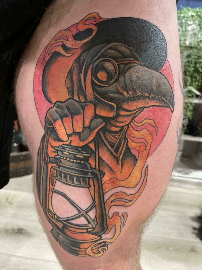 The colorful plague doctor upper leg tattoo