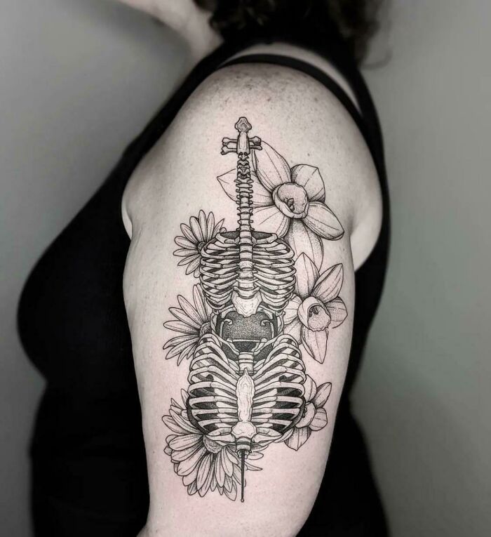Bone Cello with daisies and daffodils shoulder tattoo