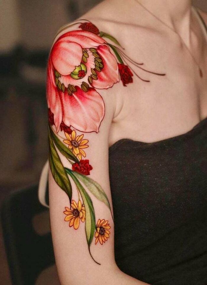 Colorful red and yellow flowers arm shoulder tattoo