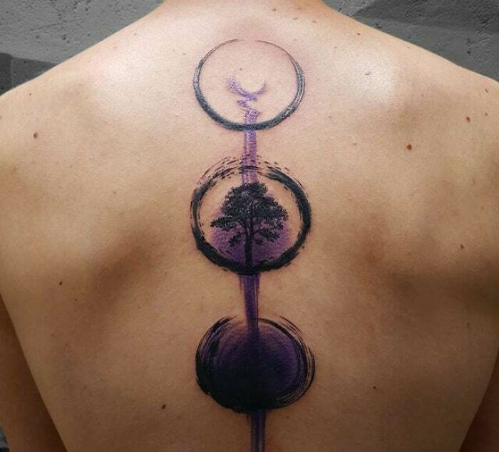 Cycle of life and death back spine tattoo