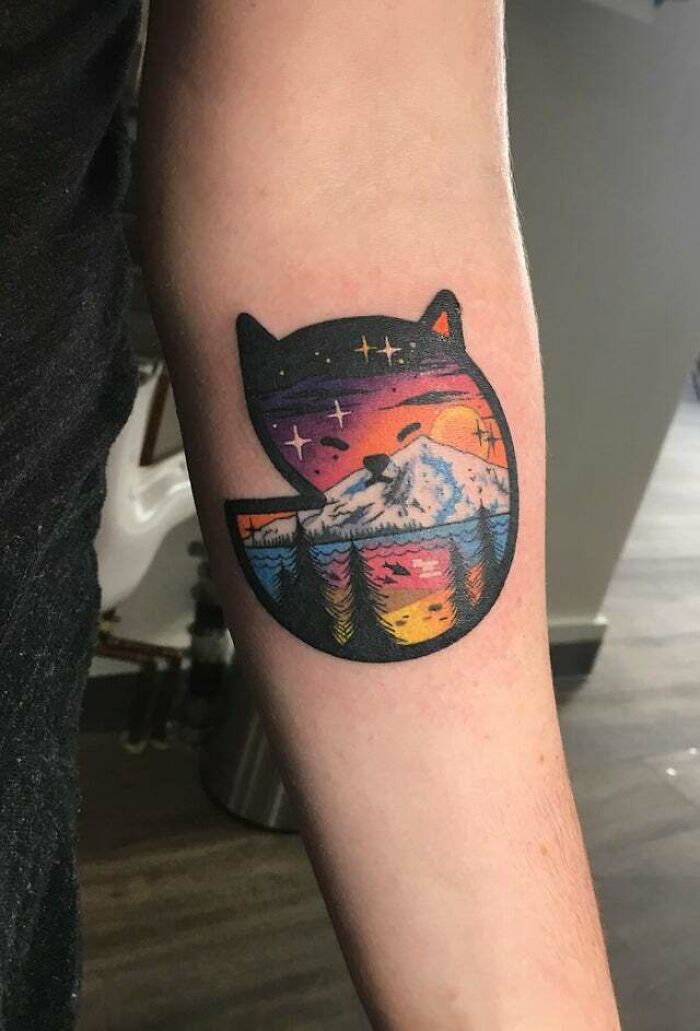 Colorful nature in cat symbol arm tatoo