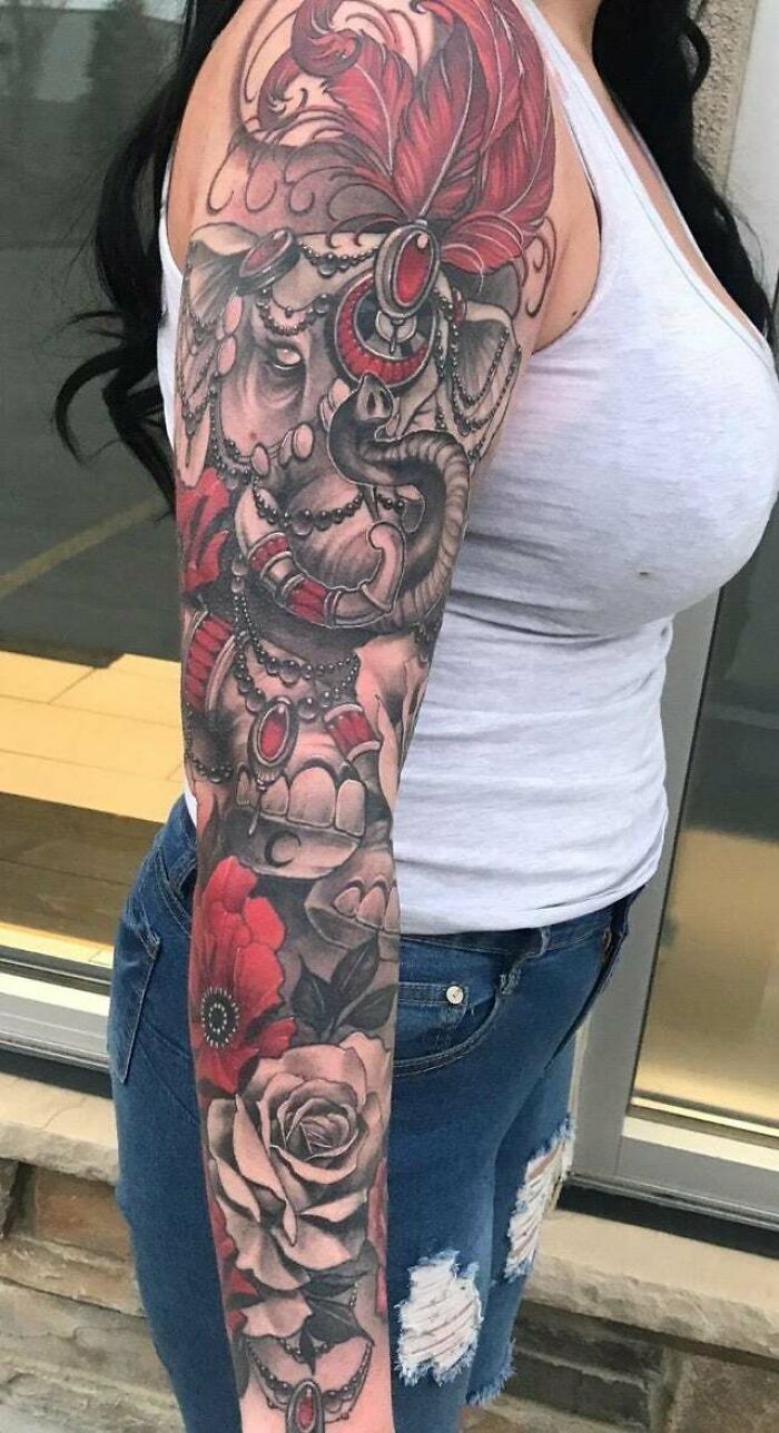 Elephant with flowers arm sleeve tattoo