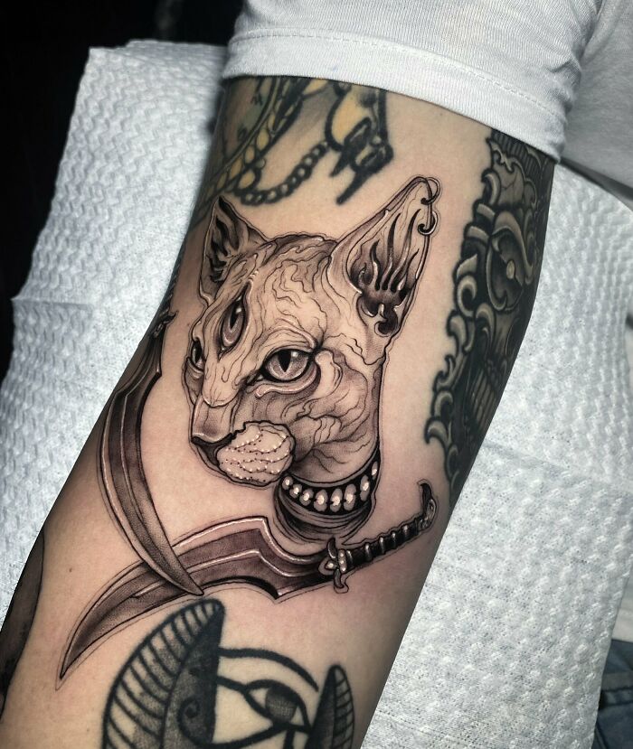 3 eye Egyptian cat with sword arm tattoo