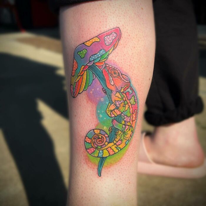 Colorful mushroom with chameleon leg tattoo