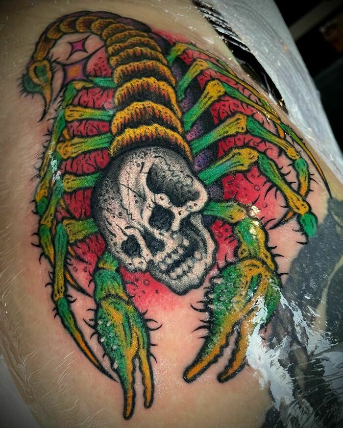 Colorful scorpion with skull tattoo