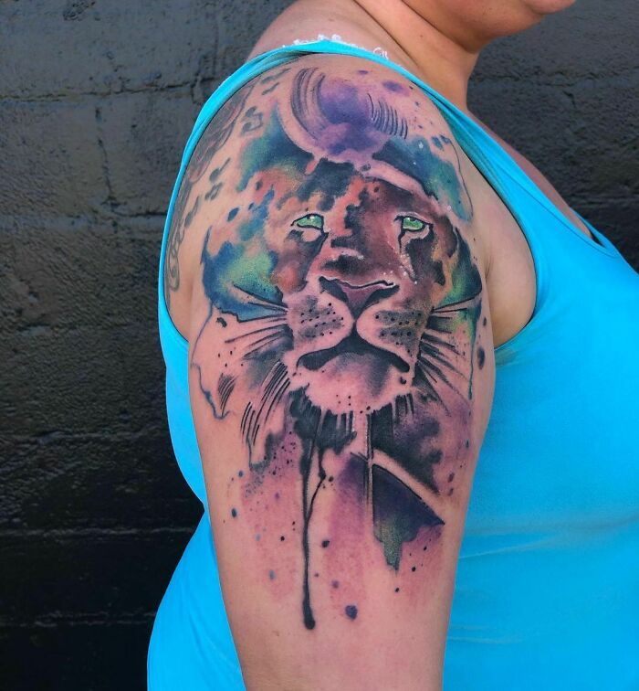 Colorful lion shoulder arm tattoo