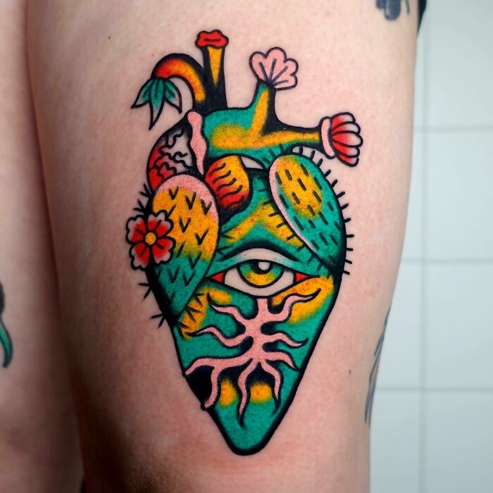 Colorful heart with eye and flowers tattoo