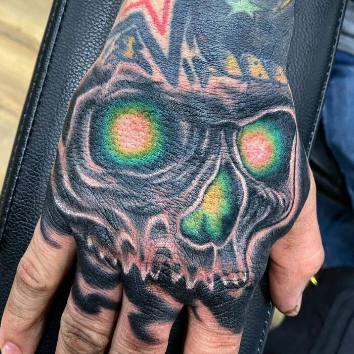 Spooky skull with glowing eyes and nose hand tattoo