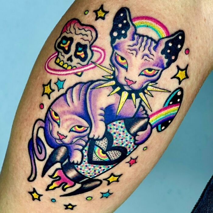 Colorful trippy egyptian cat with skull and rocket leg tattoo