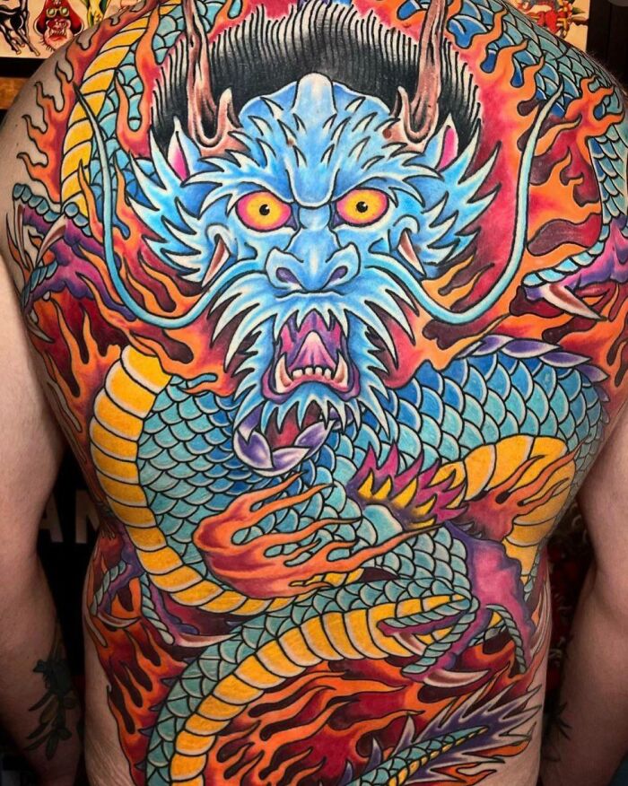 Colorful blue red dragon full back tattoo
