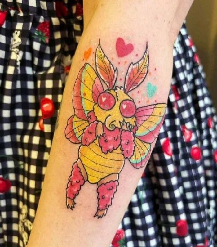 Rosy maple mothman with love symbols arm tattoo