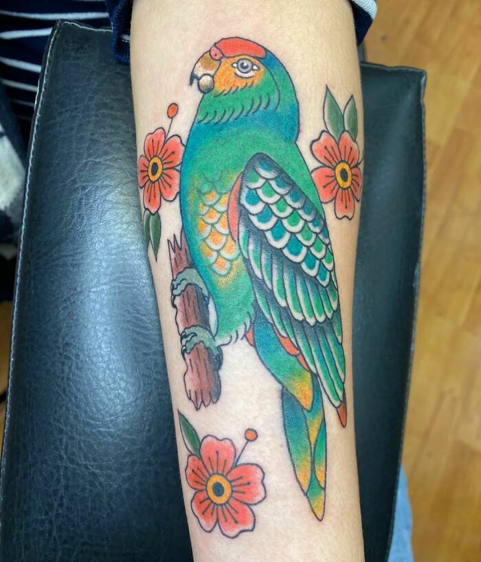 Parrot with flowers tattoo 