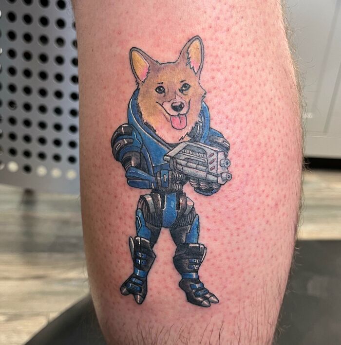 Dog robot holding a blaster tattoo 
