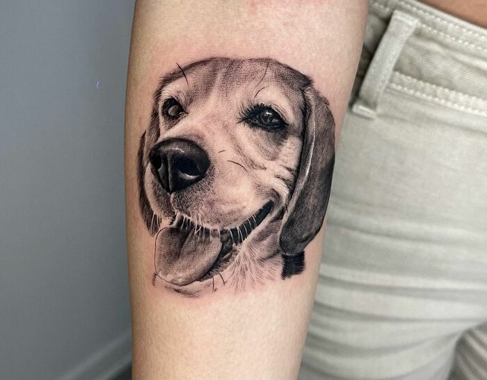 Dogs face arm tattoo 