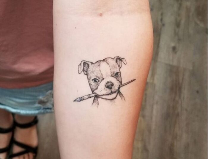 Dog holding painting brush tattoo 