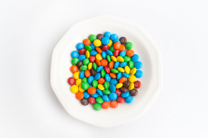 close up view of m&m candies on a white plate