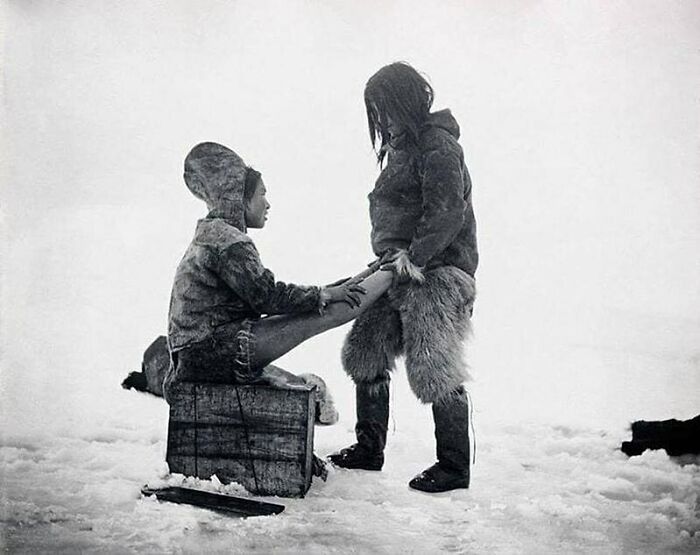An Inuit Man Warms Up His Wife’s Feet In Greenland, 1890s