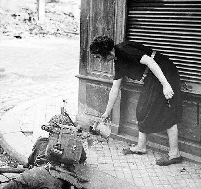French Woman Pours A Cup Of Tea For A British Soldier Fighting In Normandy, 1944