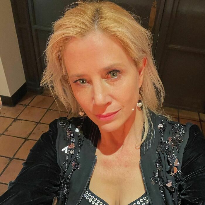 Woman posing indoors with light blonde hair and a black detailed jacket, representing smartest celebrities with intelligence.