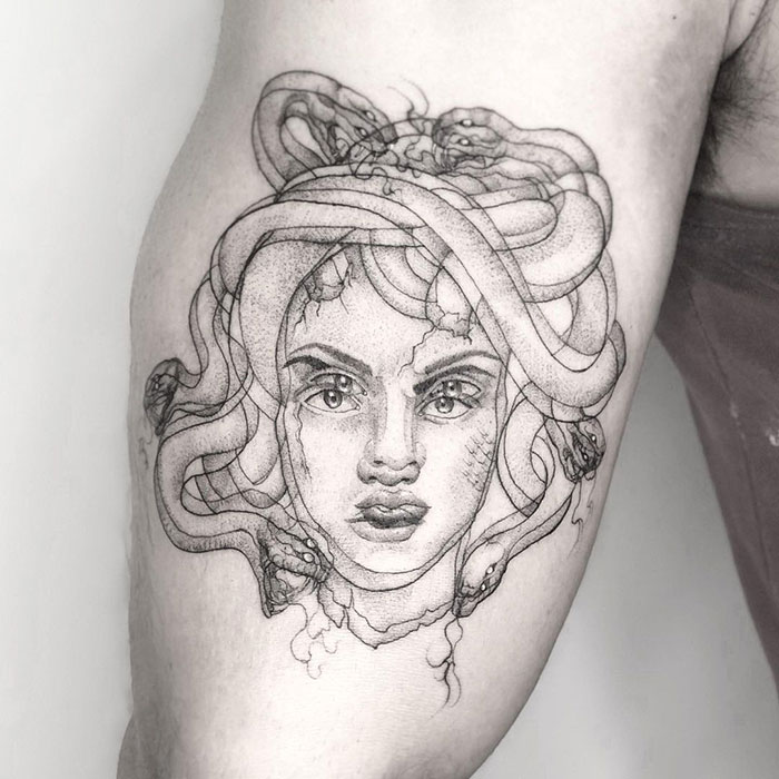 Trippy medusa blurred arm tattoo