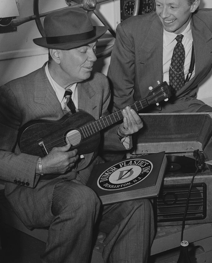 Black and white picture of Cliff Edwards playing with ukulele and singing