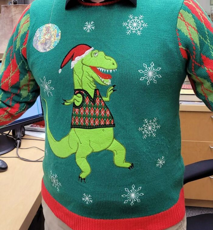 Me imagino la reunión de diseño para este jersey: "El T. Rex no es lo suficientemente festivo." "¿Podríamos añadir una bola de discoteca?" "Bingo"