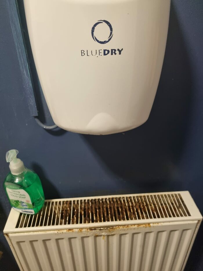 Public Toilet In A Pub. This Hand Dryer Is Directly Above This Radiator, So All The Drips From Wet Hands Are Causing This Rust And Yuckiness!