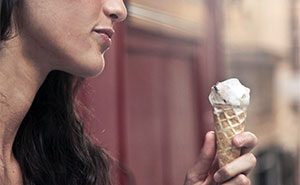 Woman Continues To Enjoy Her Ice Cream In
