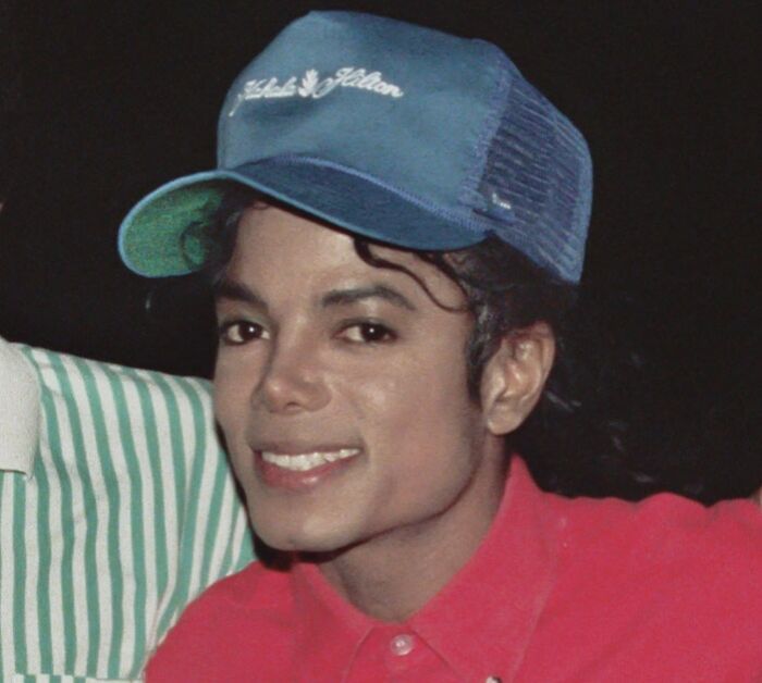 Picture of Michael Jackson with blue hat and smiling