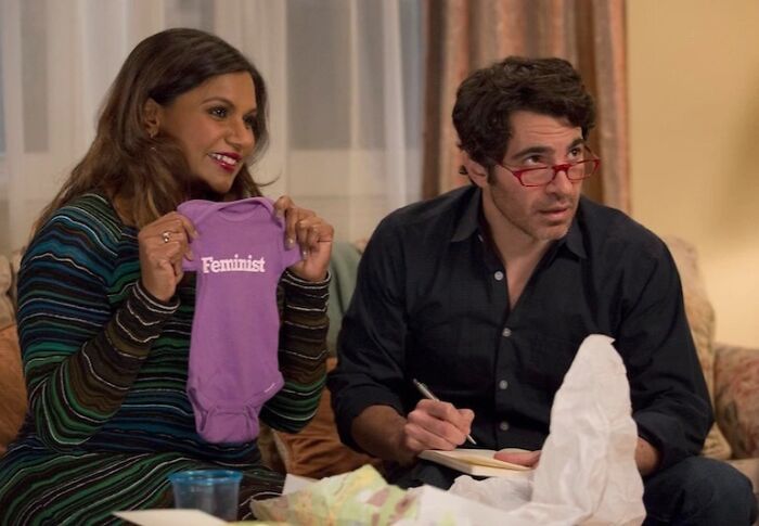 Mindy showing baby clothe 