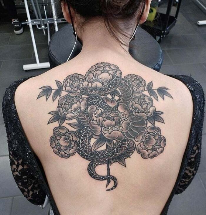 Snake with peonies back tattoo