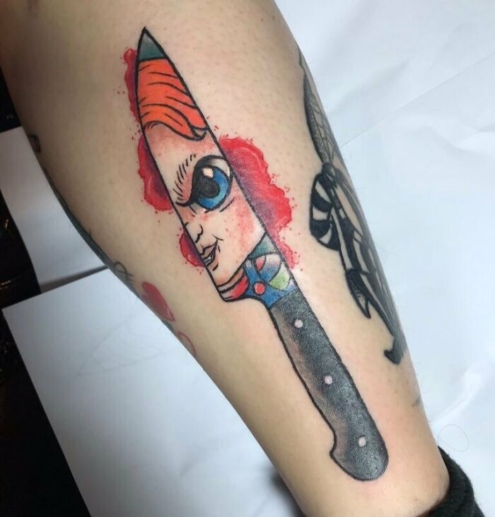 Chucky in knife arm tattoo