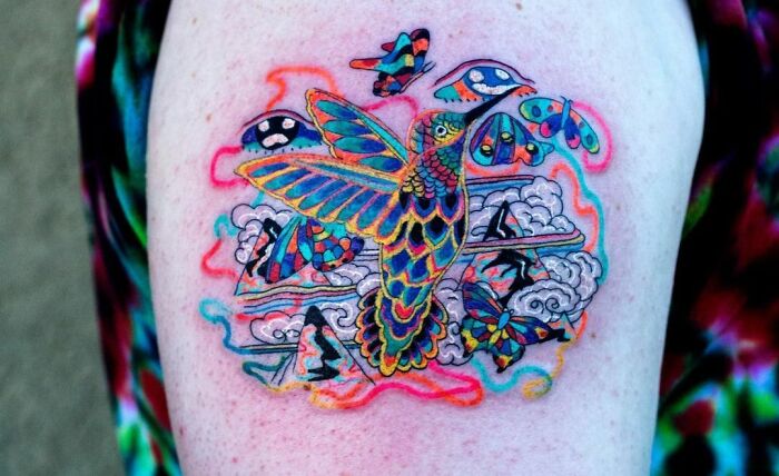 Colorful bird with butterflies shoulder tattoo