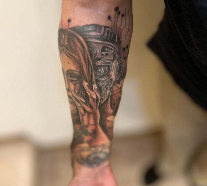 Woman and robot arm tattoo