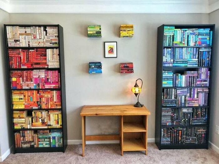 a table between two bookshelves 