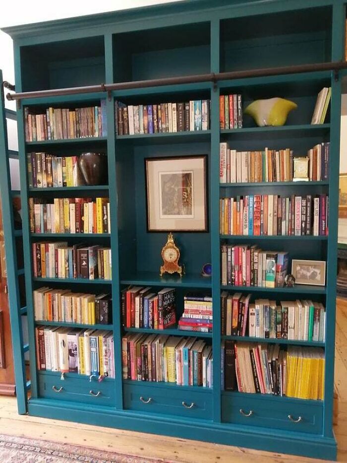 Green bookshelf with clock 