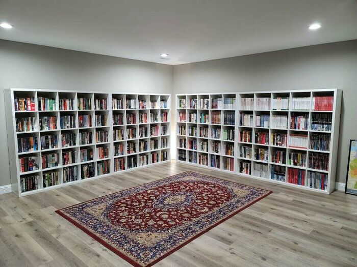 a room with bookshelf and a rug 