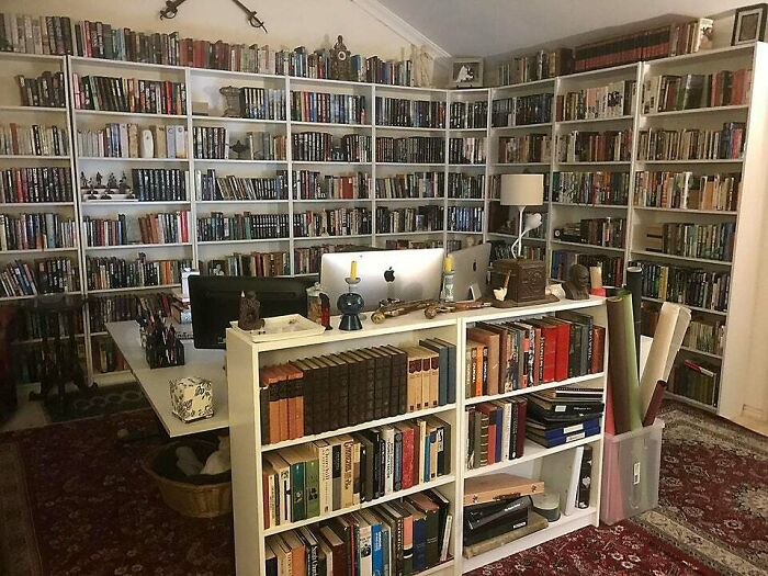 Home library with bookshelves and a table in the middle 
