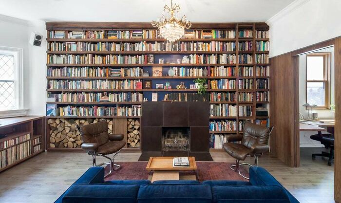 Brown leather chairs next to a fireplace 