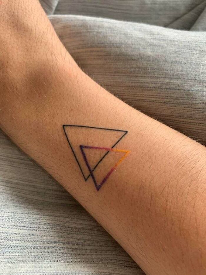 minimalistic tattoo of two triangles 